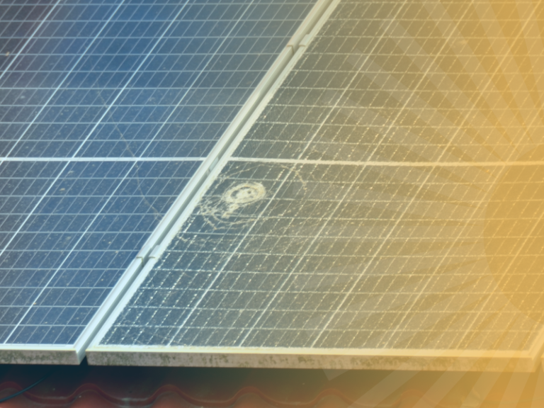 Close-up of two solar panels with a sun flare across them