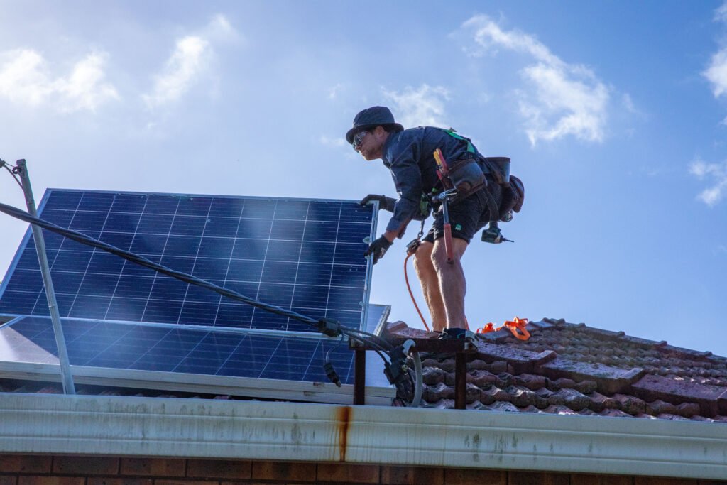 A local SAA accredited installer fitting panels on a tile roof