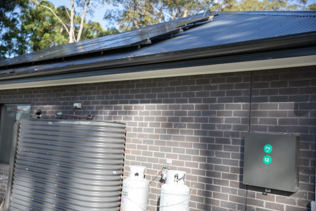 Water tanks and wall-mounted equipment at a rural install, the Central West & Riverina