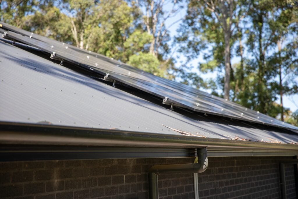 A rooftop array above wall-mounted inverter equipment, the Gold Coast