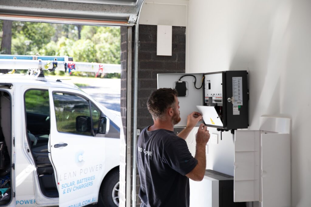 A Clean Power electrician wiring a switchboard in a garage, South Australia