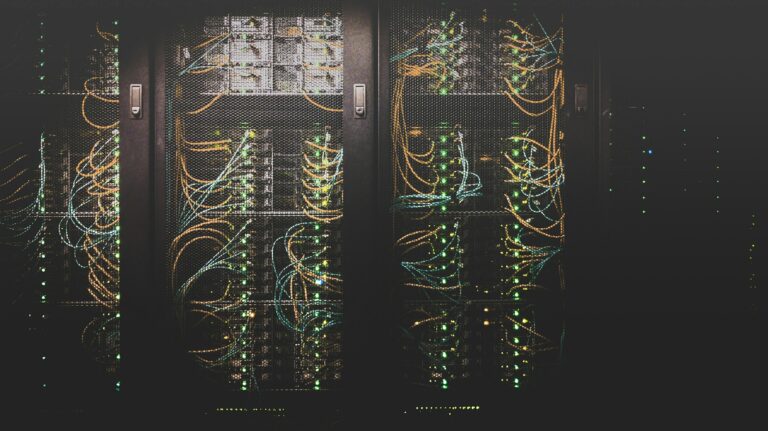 Rows of data centre server racks with glowing network cables