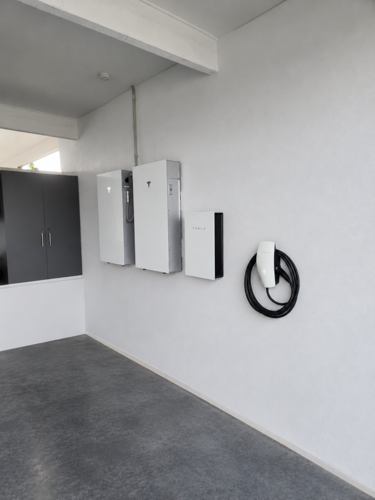 Tesla Powerwall 3 with Expansion, Backup Gateway 2 and Wall Connector EV charger in a garage